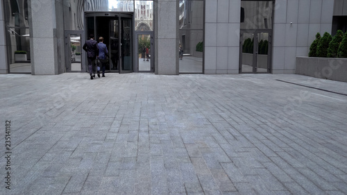 Wallpaper Mural Men in formal suits entering office center, business life, important meeting Torontodigital.ca
