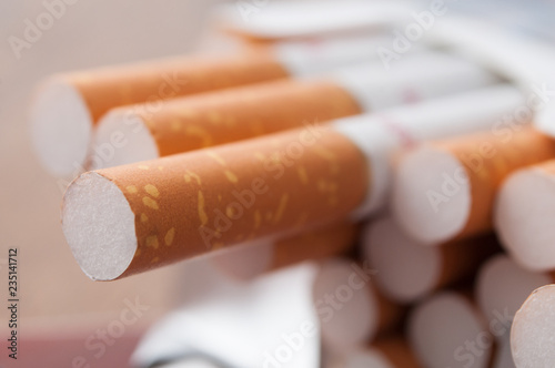 closeup of cigarettes in cigarettes pack  on wooden table background photo