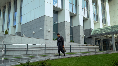 worker leaving office center after long working day professional burnout