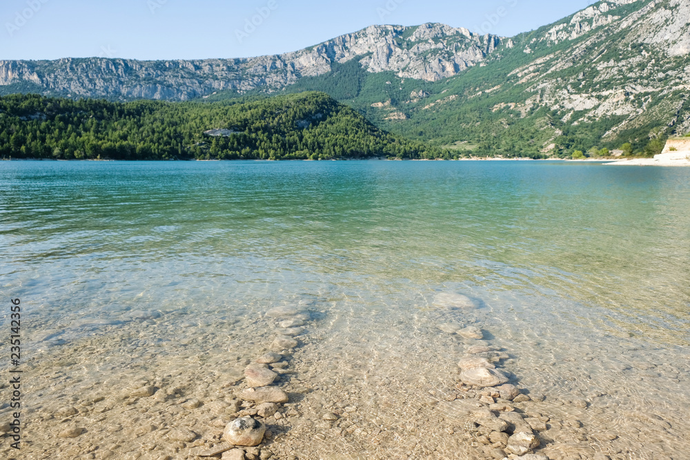 Stones in the water show the route. Artificial lake of Sainte-Croix-du-Verdon. Provence. France.