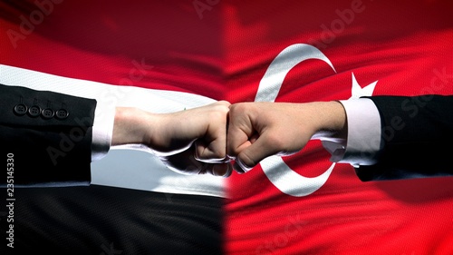 Syria vs Turkey conflict, international relations, fists on flag background © motortion