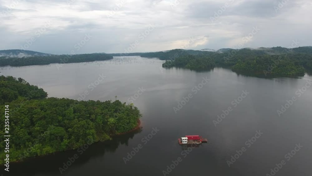 Flying towards a supply boat on a giant lake reservoir Petit Saut dam Guiana Flying towards a supply boat on a giant lake reservoir Petit Saut dam Guiana