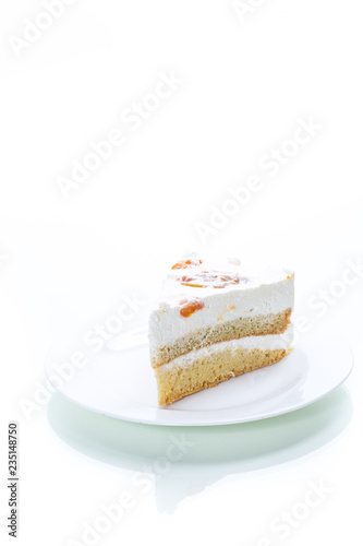 a piece of homemade sweet cake with cream and canned apricots