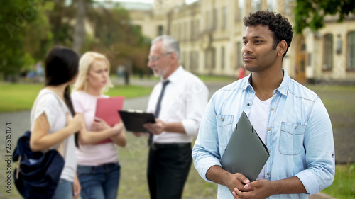 Mixed-race male student looking into distance, higher education and future