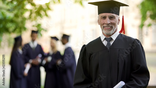 Canvastavla Aged man in graduation outfit, professor obtaining new degree, academic career