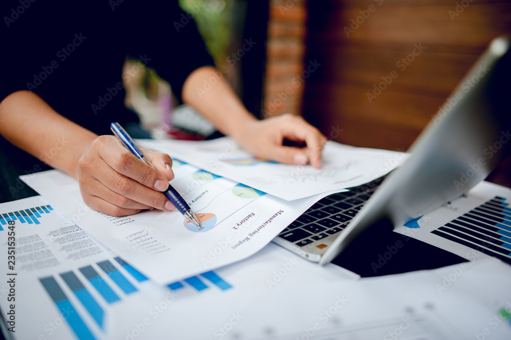 Businessman working at a computer office And graphs on his desk. Business ideas and space for copy. Businessman working at a computer office And graphs on his desk. Business ideas and space for copy.