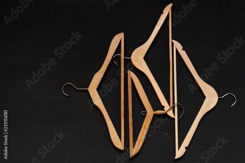 old wooden hangers for fashionable things on the background photo