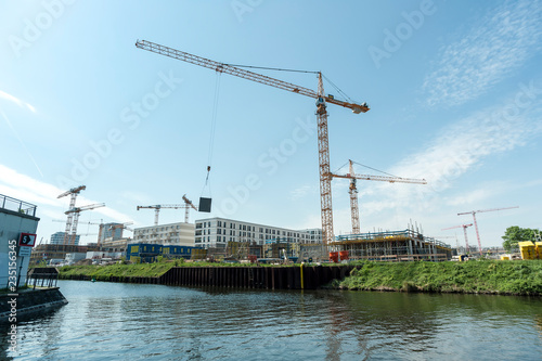 Operating crane at building site.