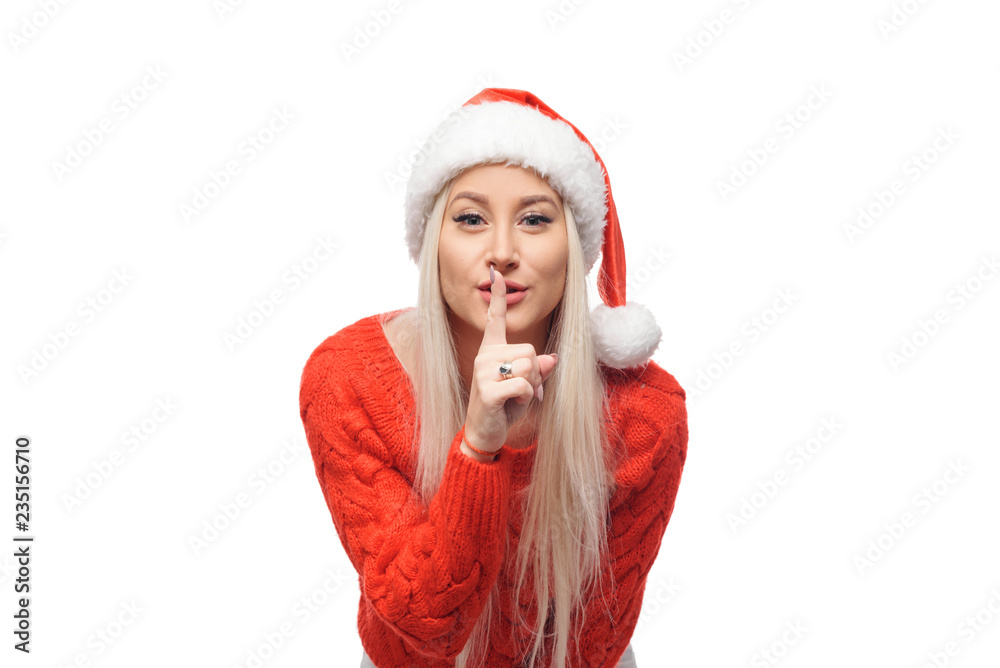 Shocked Christmas woman in santa hat showing silence sign on isolated white background