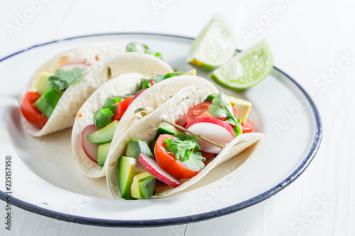 Vegetarian tacos as a snack on white table
