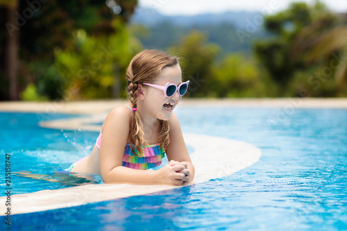 Child in swimming pool. Summer vacation with kids. © famveldman