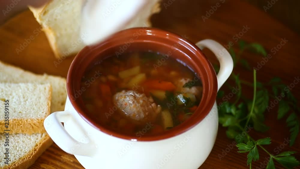 vegetable soup with beans and meatballs in a ceramic bowl vegetable soup with beans and meatballs in a ceramic bowl
