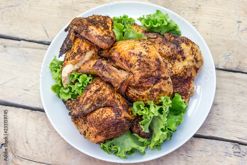 Dish with pieces of grilled chicken with salad