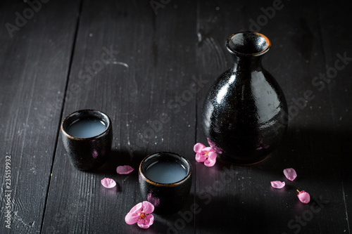 Sake in black ceramics on dark table