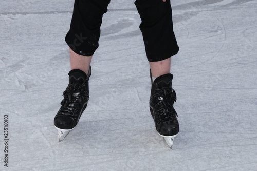 men's feet skating on ice