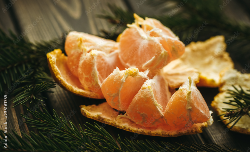 Juicy ripe mandarin and spruce needles. New Year's scenery Juicy ripe mandarin and spruce needles. New Year's scenery