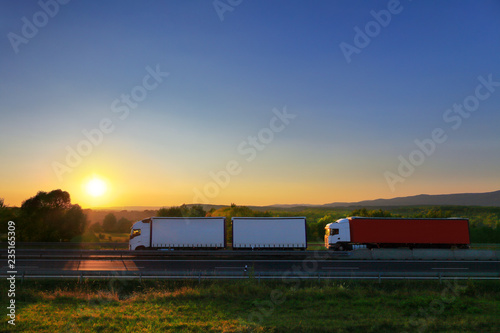 Truck transport on the road at sunset