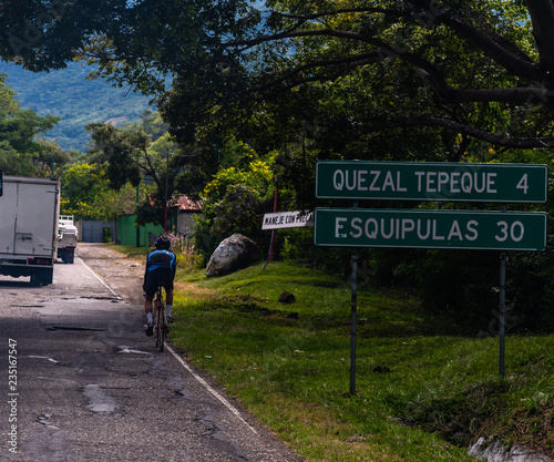 Guatemalan man on bike on main road photo