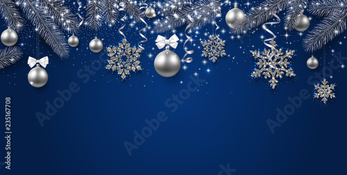 Blue shiny festive banner with fir branches, silver balls and snowflakes.
