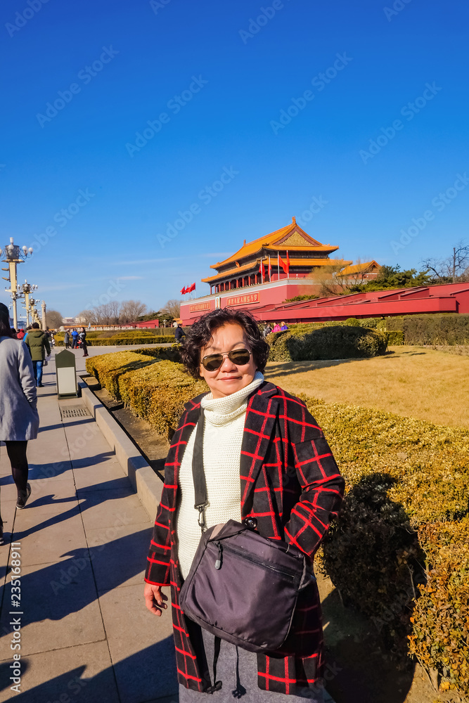 Beijing/China - 25 February 2017:Portrait photo of Senior asian women with Forbidden Palace at beijing Capital City of china