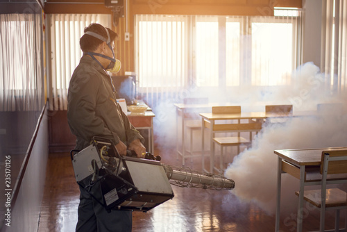 Man work fogging to eliminate mosquito for preventing spread dengue fever and zika virus