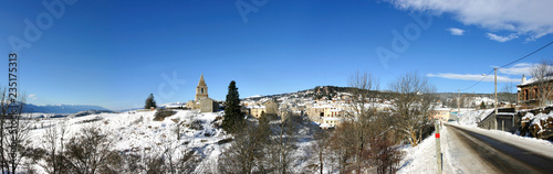 Typical village and church under the snow in the mountains of pyrenees