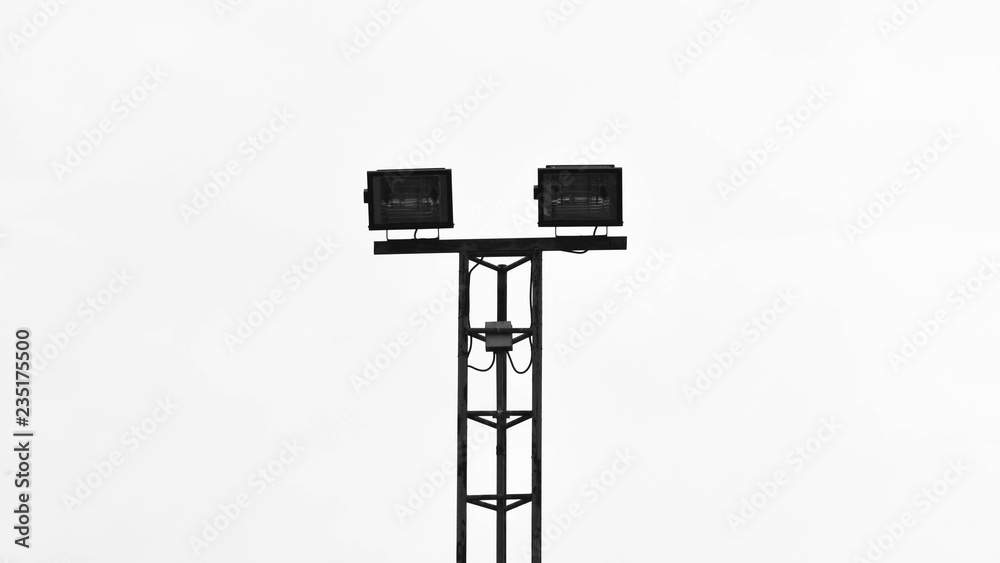 stadium lights at tennis court on pale white background - monochrome stadium lights at tennis court on pale white background - monochrome