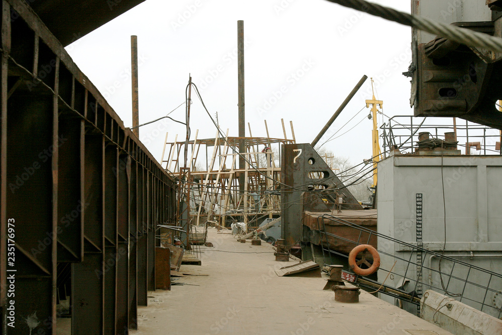 Archive 2008 River port of Ust-Danube was destroyed in of crisis. Old rusty boats on stocks in dry dock of river port. Old river vessels rust on dock repair shop stocks for repair of river vessels