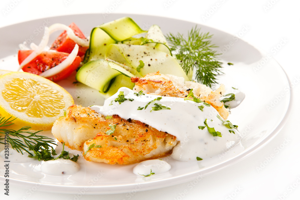 Fried cod and vegetables on white background Fried cod and vegetables on white background