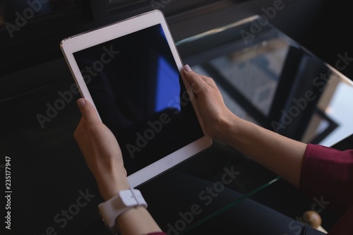 Female executive holding digital tablet in office