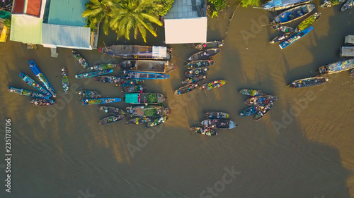 AERIAL: Locals buying and selling fruits and vegetables from their wooden boats.