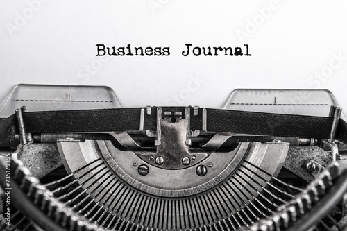 Business journal, text is typed on an old vintage typewriter with white paper. Business idea