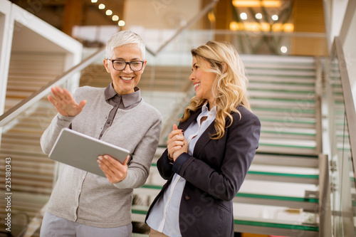 Senior and young businesswo...