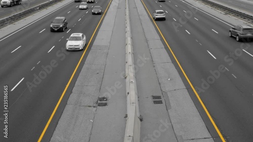 Looking down at highway with traffic. Black and white with yellow lines. Gardiner Expressway in Toronto, Ontario, Canada. photo