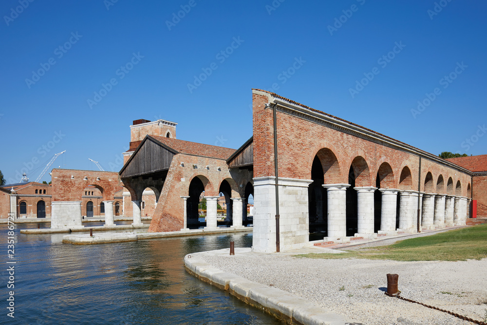Venetian Arsenal with docks and arcade in a sunny day in Venice, Italy