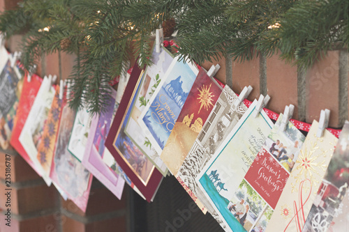Christmas photograph of Christmas cards strung over a fireplace mantel