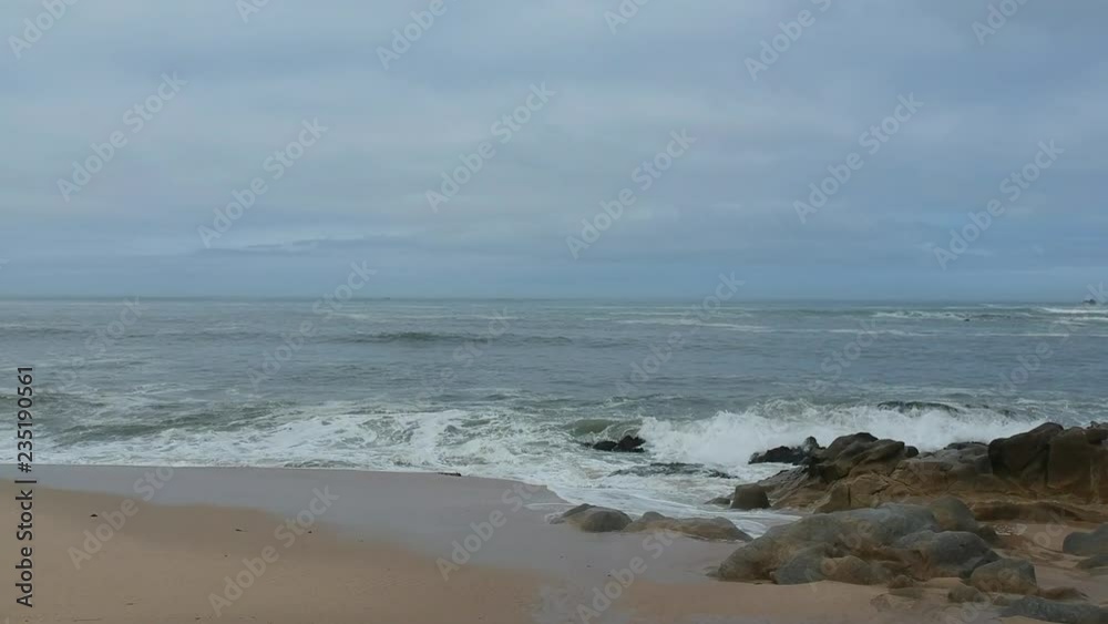 Aerial flying forward over beach in winter, grey ocean and overcast sky Aerial flying forward over beach in winter, grey ocean and overcast sky