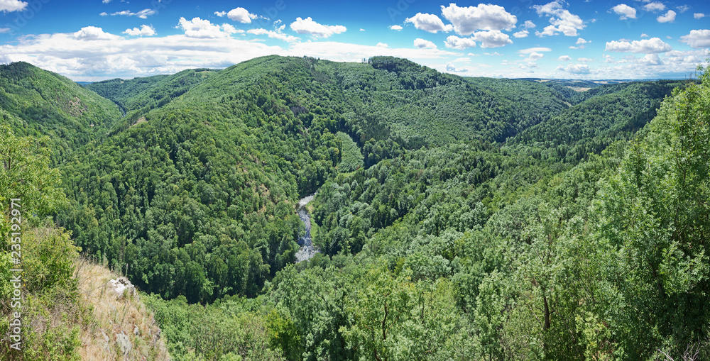 Panoramic view over Kamp river valley overgrown by natural primeval-like forest in Austria.