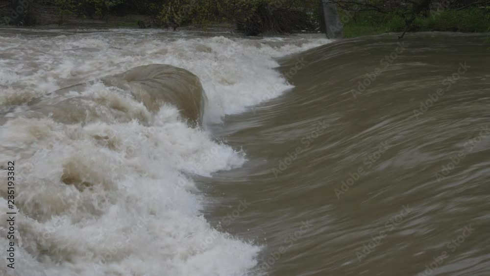 Smooth water meets rough at site of a man made weir. Weirs are