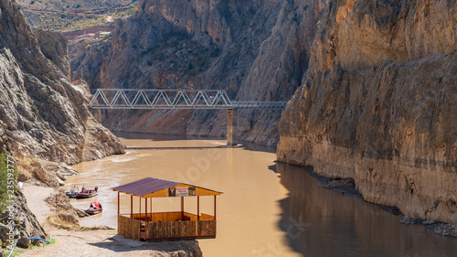 Landscape view of Dark Canyon with tour boats and wooden pier in Town of Kemaliye or Egin in Erzincan,Turkey photo