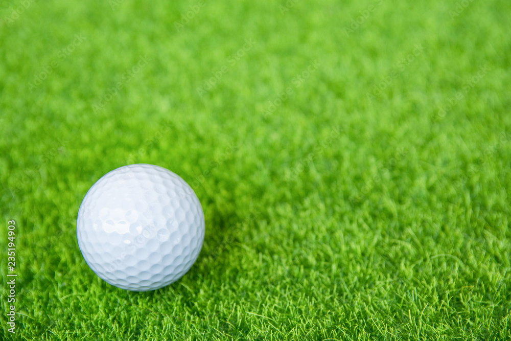 Golf ball on green grass ready to play at golf course. with copy space Golf ball on green grass ready to play at golf course. with copy space