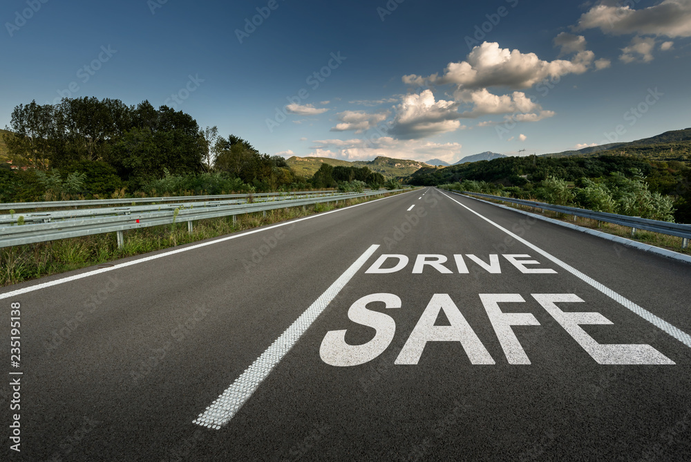 Drive safe message on Asphalt highway road through the countryside to the mountains