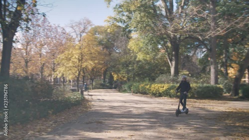 Wallpaper Mural Modern Man with Electric Scooter Stops on the Bench in Sunny Park Torontodigital.ca