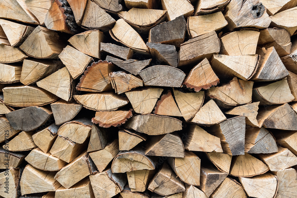 Dry chopped firewood logs ready for winter, Firewood wall background texture Dry chopped firewood logs ready for winter, Firewood wall background texture