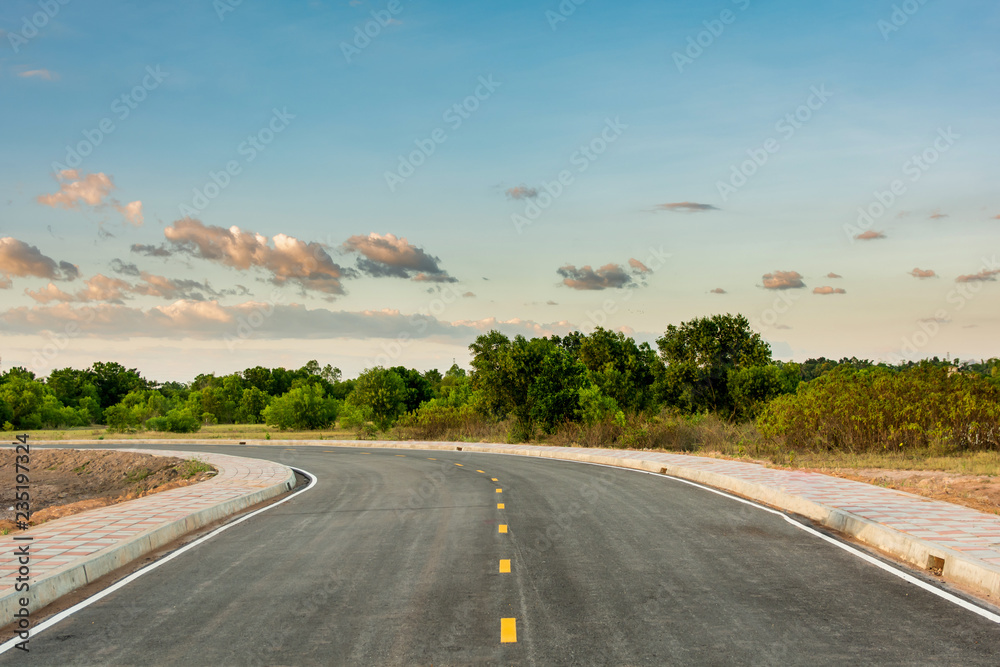 Empty asphalt road curve and clean blue sky in summer day background with copy space