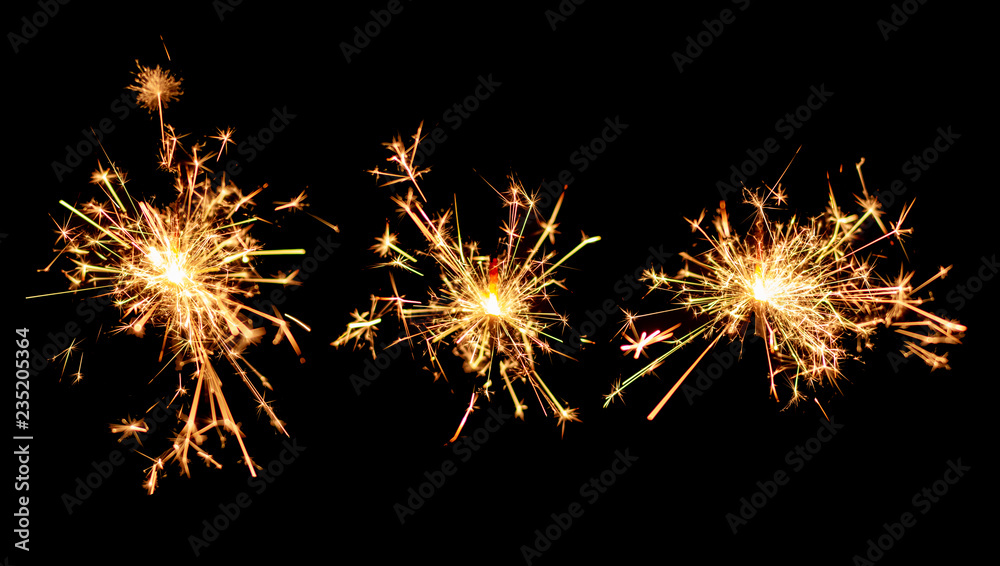 Set of Christmas sparkler burning isolated on black background. Set of Christmas sparkler burning isolated on black background.