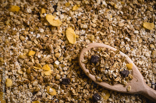 wooden spoon with oats, cereal and seeds.