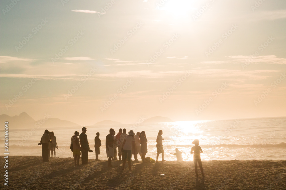 group of tourists enjoying sunshine on the sand of Copacabana beach in rio de janeiro