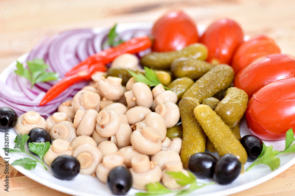 Pickles in assortment on a plate. Restaurant dish. Pickles in assortment on a plate. Restaurant dish.