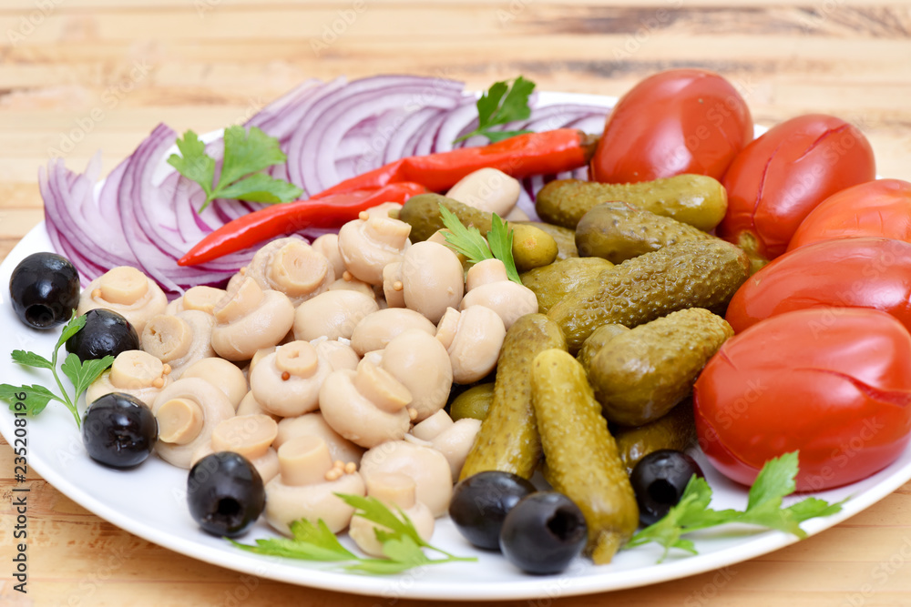 Pickles in assortment on a plate. Restaurant dish. Pickles in assortment on a plate. Restaurant dish.